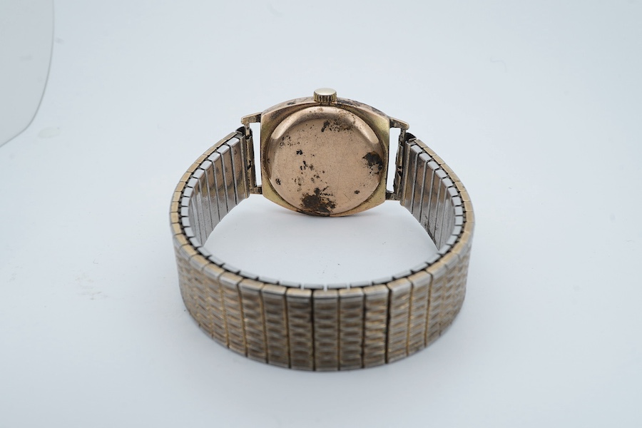 A 1930's 9ct gold Rolex manual wind wrist watch, with Arabic dial and subsidiary seconds, retailed by Grant & Son, Carlisle, on an associated gold plated flexible strap, case diameter 28mm (hand loose in dial). Condition
